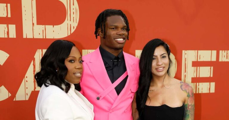 Travis Hunter walks on the red carpet with the bride
